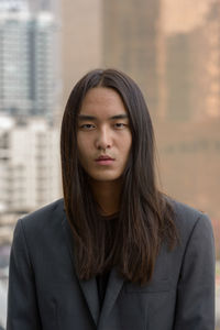 Portrait of man standing in city