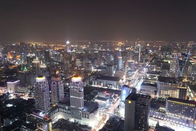 High angle view of illuminated cityscape against sky at night