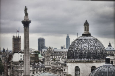 Buildings against cloudy sky