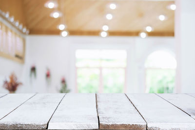 Wooden table in illuminated room