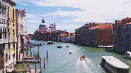 Boats in river with buildings in background