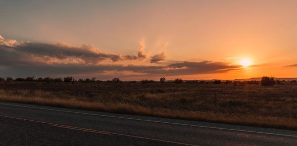 Scenic view of field against sky during sunset