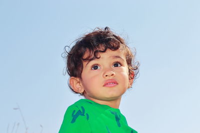 Portrait of cute boy against clear sky