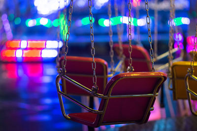Close-up of swing ride at night