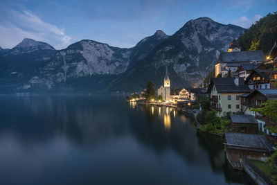 Panoramic view of lake and buildings against mountains