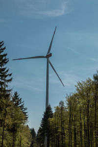 Low angle view of windmill against sky