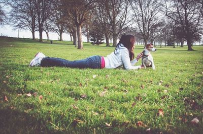 Girl relaxing on grassy field in park