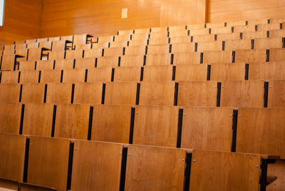 Close-up of chairs in row at auditorium