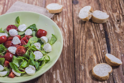 High angle view of chopped fruits in bowl on table