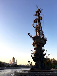 Low angle view of statue in temple against clear sky