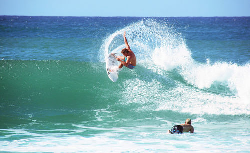 People surfing in sea