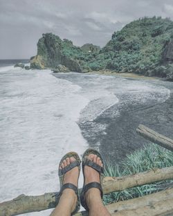 Low section of person on sea shore