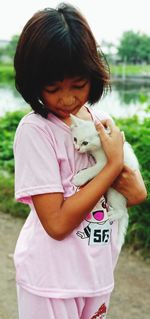 Portrait of cute girl with pink standing outdoors