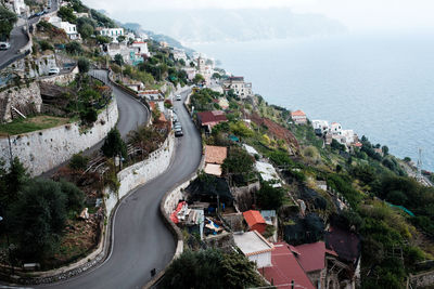 High angle view of road by buildings and sea