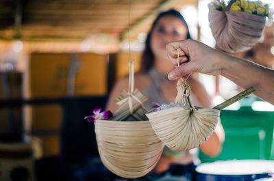 Cropped hand of child holding wicker basket