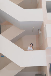 Portrait of young woman on staircase