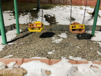 High angle view of yellow car on snow covered land