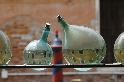 Close-up of glass bottles filled with water