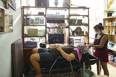 Senior man getting hair washed in hair salon