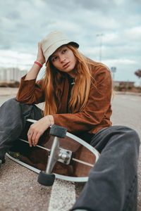 Portrait of young woman sitting outdoors