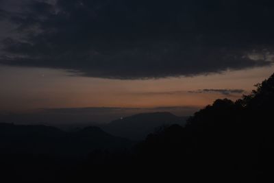 Scenic view of silhouette mountains against sky at sunset