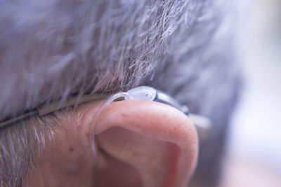 Close-up of man ear with hearing aid