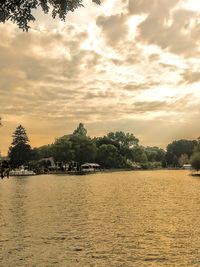 Scenic view of lake against sky at sunset