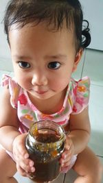 Close-up portrait of cute boy holding camera