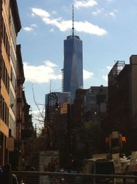 Low angle view of buildings against cloudy sky