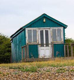 Abandoned building on field against sky