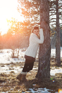 Side view of woman on snow covered land