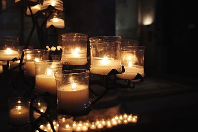 Close-up of illuminated tea lights on table