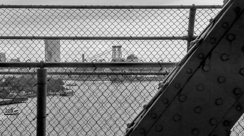 Close-up of chainlink fence against sky