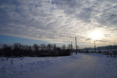 Snow covered road against sky