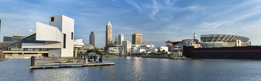 View of buildings at waterfront against cloudy sky