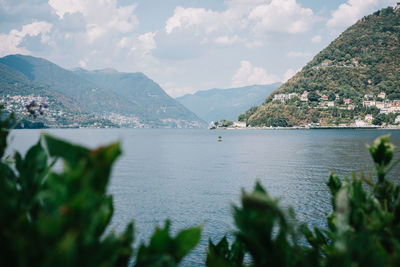 Scenic view of sea and mountains against sky