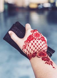 Cropped image of woman with henna tattoo