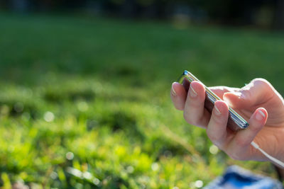 Cropped hand of person holding mp3 player 