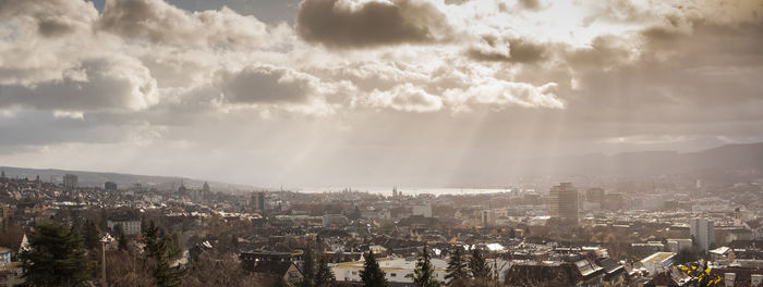 High angle view of city against cloudy sky