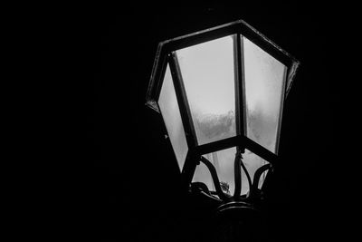 Close-up of electric lamp in darkroom