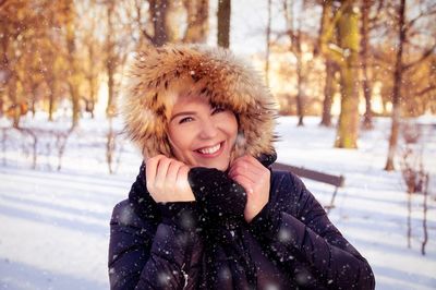 Portrait of smiling young woman in snow