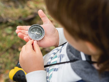 Little explorer on hike in forest. boy with binoculars and compass. summer journey for tourist.