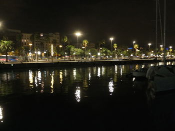 Reflection of illuminated city in water at night