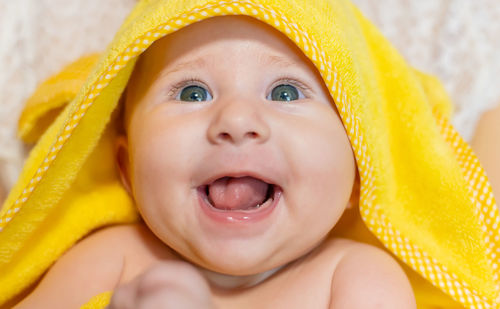 Cheerful baby girl wearing towel