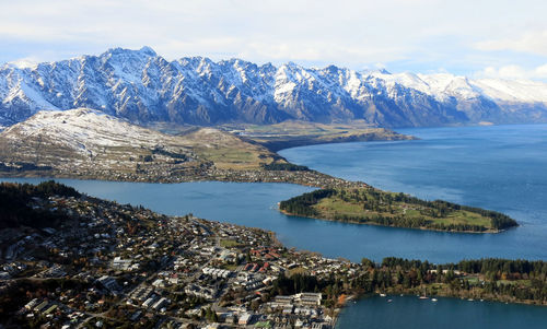 Scenic view of sea and mountains against sky