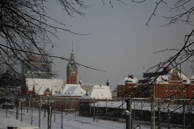 Snow covered city against sky