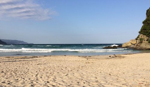 Scenic view of beach against clear sky