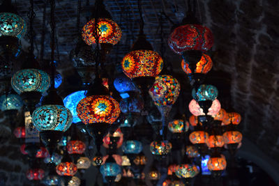 Close-up of illuminated lanterns hanging at night