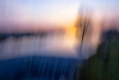 Blurred motion of sea against sky during sunset