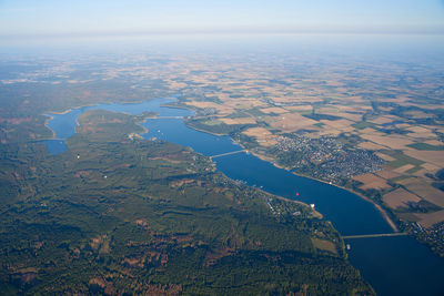 Aerial view of river amidst field against sky